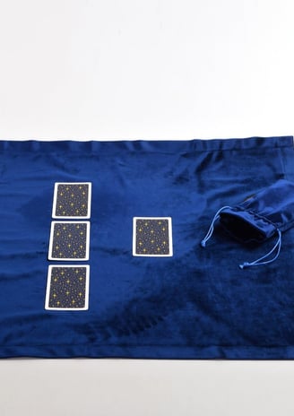 a blue cloth bag with four playing cards