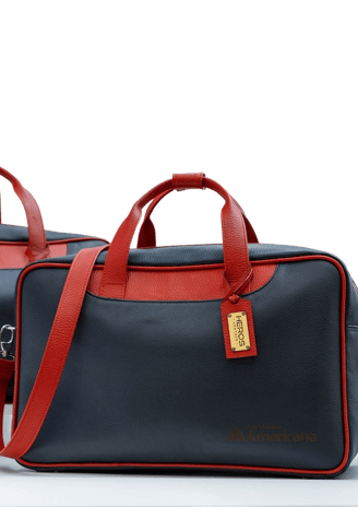 two bags of luggage with a red and blue one by heros leather