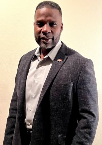 Dr. Marlon Ware standing in casual suit