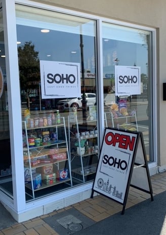 a sign boarder in front of a store