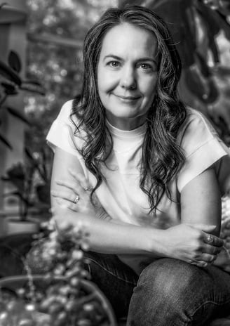 a woman sitting on a chair in a garden