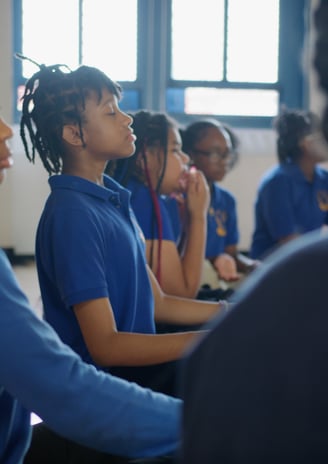 Students practicing deep breathing.