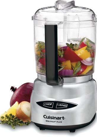 a food processor with a blender and vegetables