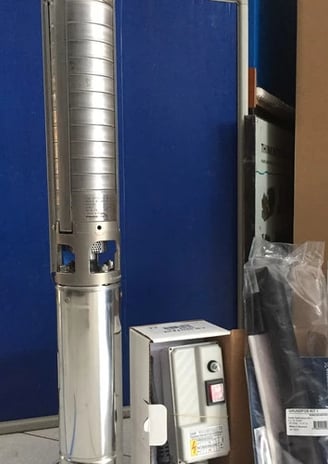 a metal and metal water pump with a blue background