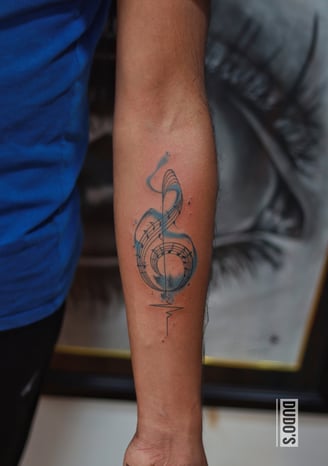 Watercolor music symbol tattoo at Dudo's Tattoos Hyderabad