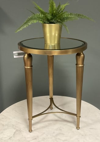 brass end table with greenery