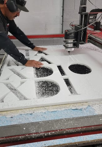One of our employees working on one of our signs