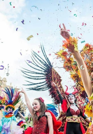 Carnival dancers in front of a church. 