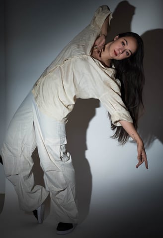 a woman in white pants and a white shirt