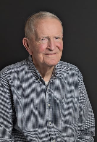 an old man in a blue shirt and a white shirt