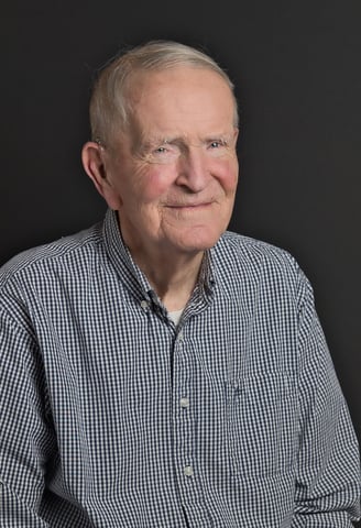 an old man in a blue shirt and a white shirt