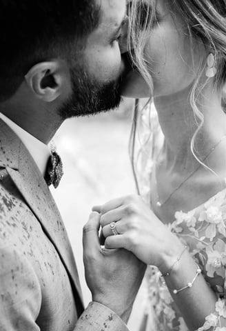 Editorial black and white fine art wedding photo of couple kissing in the rain in South of France