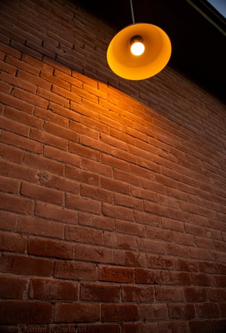 brick wall with names and a lamp in Tucson Arizona