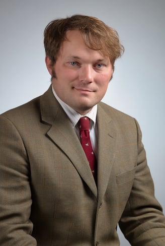 a man in a suit and a red tie and a white shirt