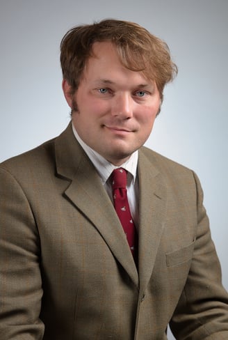 a man in a suit and a red tie and a white shirt
