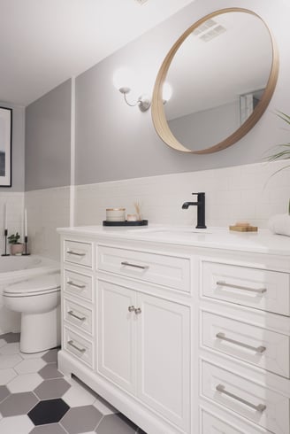 a bathroom with a white toilet and a large mirror