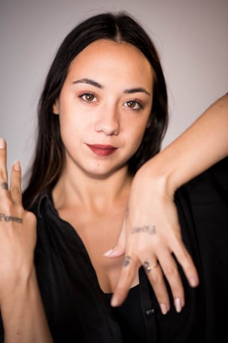 a woman with tattoos on her hands and a tattoo on her hand