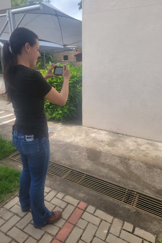 a woman is taking a picture of herself in the street