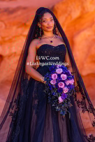 a woman in a black dress with a veil and veil