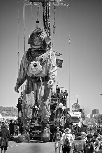 Peter Pickering photographs a giant man in a diving suit in Perth.