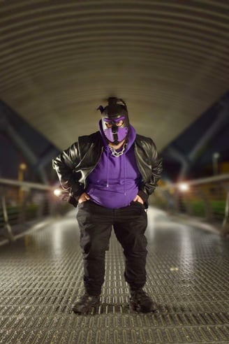 A man in a pup mask outdoors at night.