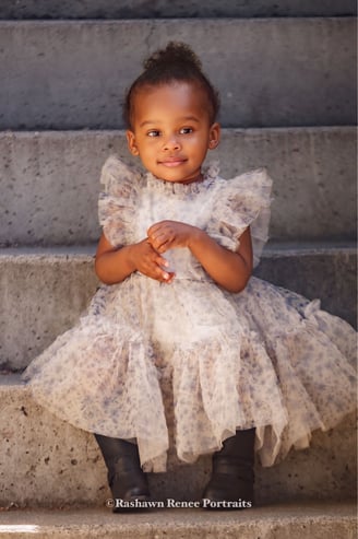 a young girl in a dress and boots