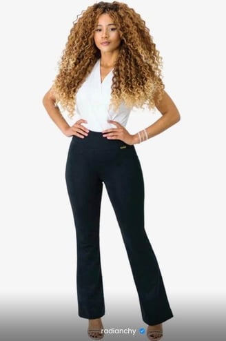 a woman in a white shirt and black pants