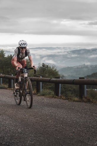 a woman riding a bike on a road