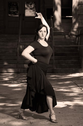 a woman in a dress dancing in a latin dance style