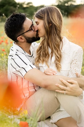 Editorial fine art photo of couple embracing in Provence poppy field