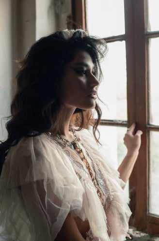 a woman in a white dress and a necklace