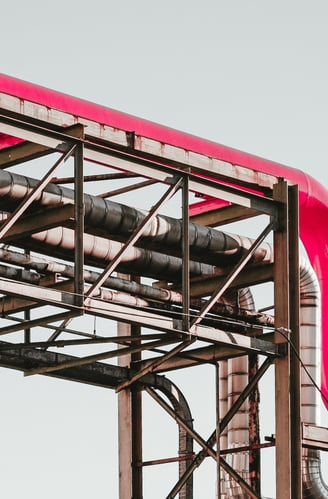 a red pipe pipe on a metal structure