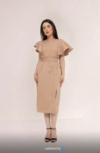 a woman in a beige dress with a brown dress