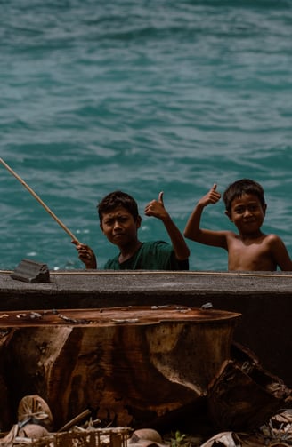 two boys in a boat on the water