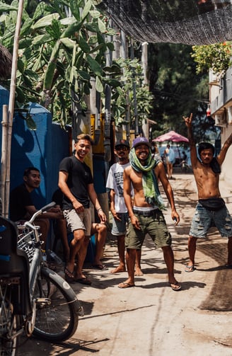 a group of indonesian people standing around a bicycle