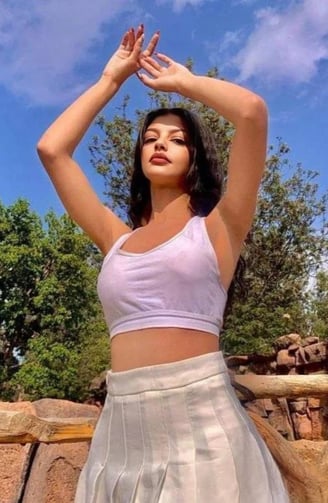 a woman in a white top and skirt with a white skirt