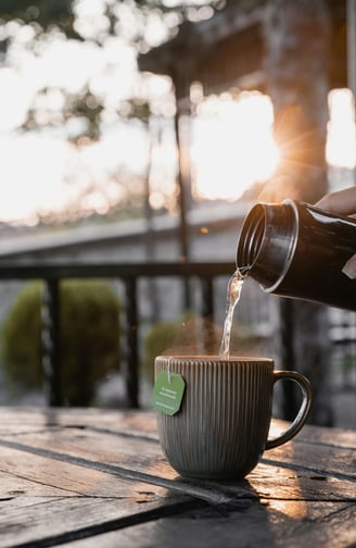 pouring water into a cup of tea