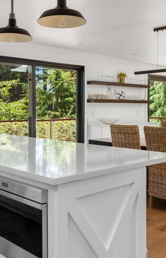 a kitchen with a large window and a table with chairs