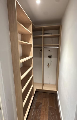 a closet with a closet door open and a closet with shelves