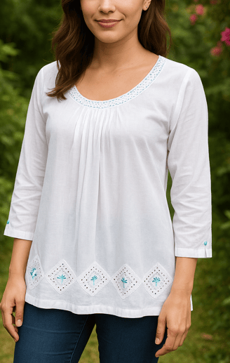 a woman in a white shirt and jeans standing in front of a bush