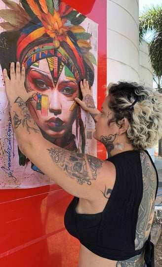 Amanda Amorim finalizando a colagem de sua obra de lambe-lambe no Centro Cultural Valdo Varjão.
