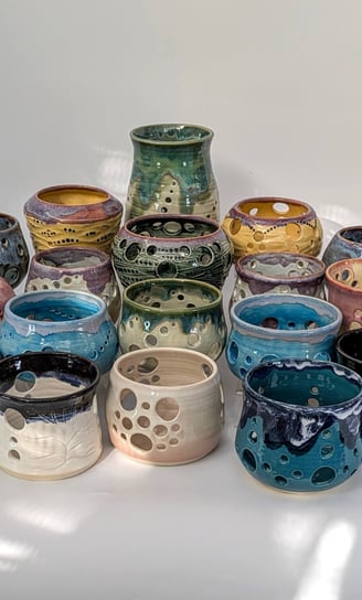A collection of GonPotty ceramic tealights