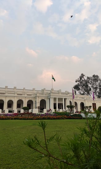 a large white building with a bird flying over it