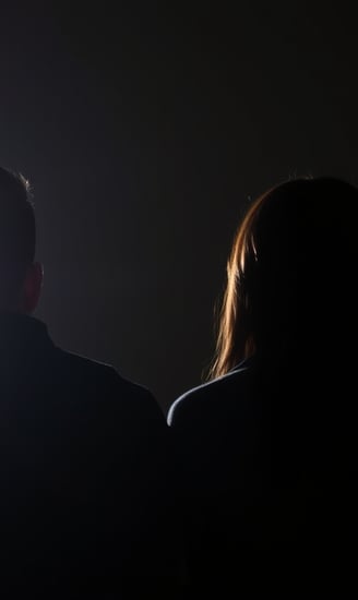a couple watching television in the dark