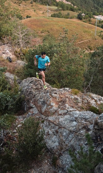 a man is running on a rocky trail
