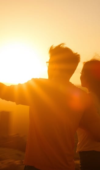 a couple standing in front of a sunset