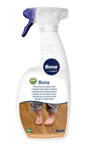 a person standing on a wooden floor with a bottle of bona bona