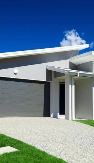 a house with a garage door and a driveway