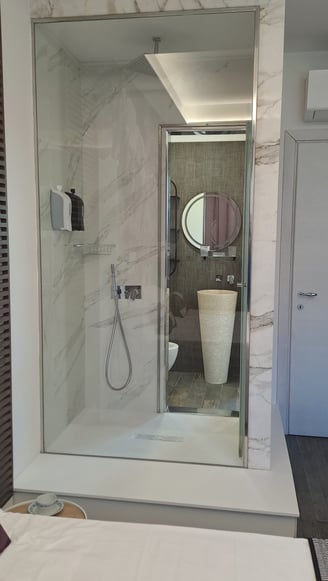a bathroom with a shower and a large mirror