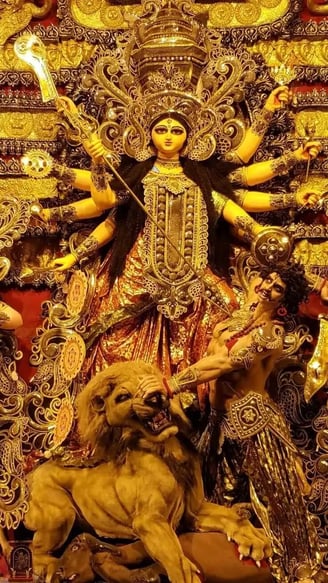 a statue of a Maa Durga with a lion on her head